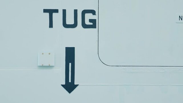 Industrial Tug Boat Safety Sign and Arrow Graphic on Vessel Hull
