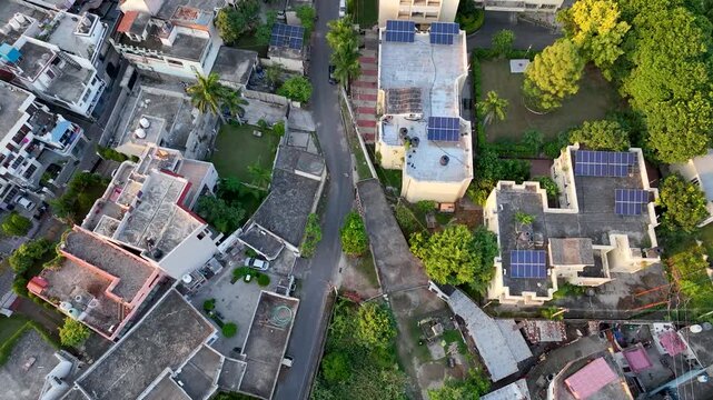 Top-down aerial view of Indian residential rooftop solar panels, capturing the massive 2026 expansion of green energy infra under PM Surya Ghar Yojna