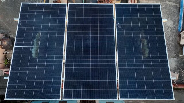 Top-down aerial reveal of Indian residential rooftop solar panels, capturing the massive 2026 expansion of green energy infra under PM Surya Ghar.
