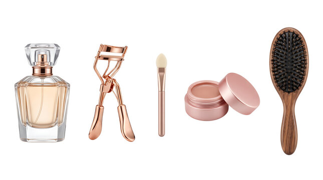 Makeup beauty tools collection featuring glass perfume bottle lash curler cream eyeshadow pot makeup blending brush and wooden hair styling brush.