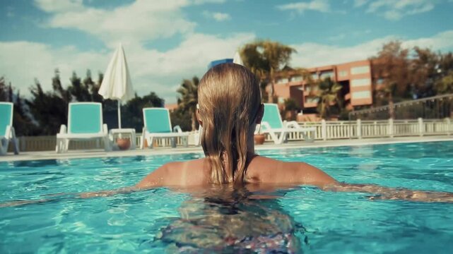 Person Relaxing In Outdoor Swimming Pool At Tropical Resort. Summer Vacation And Travel 