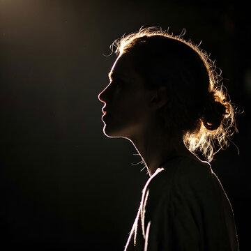 A dramatic side profile with a glowing outline, mysterious atmosphere.