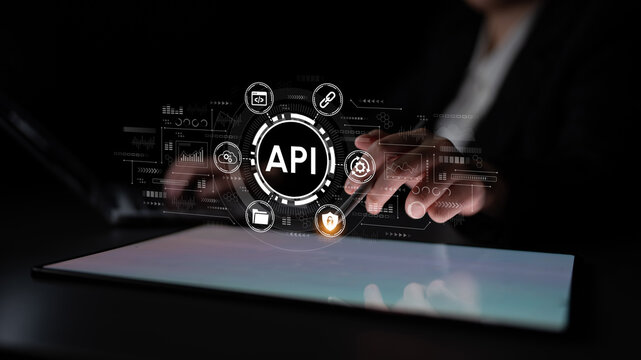 Hands Using Tablet with Digital API Icons and Symbols, Focusing on Technology, Connectivity and Data Integration in Modern Business Environment. Entropy.