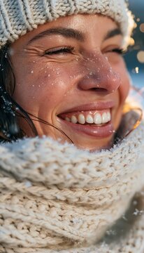 Joyful woman smiling in winter wearing cream knit scarf and hat