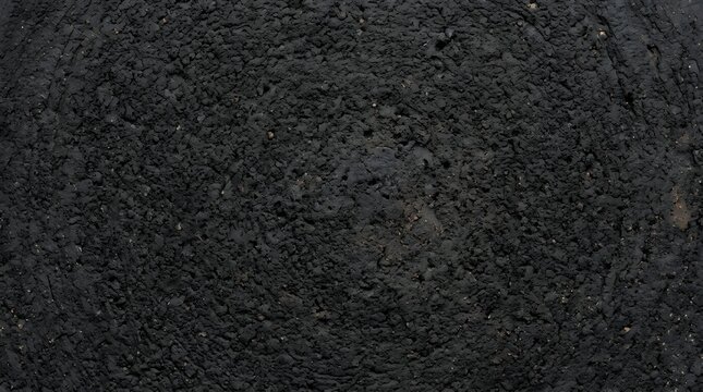 Dark black volcanic basalt stone texture with porous surface
