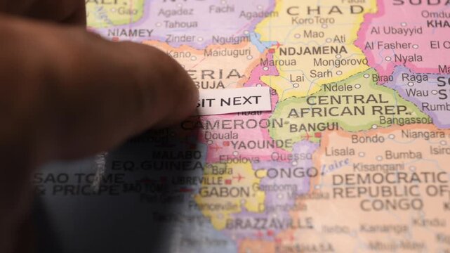 Visit Next paper note placed on a map of Africa travel concept