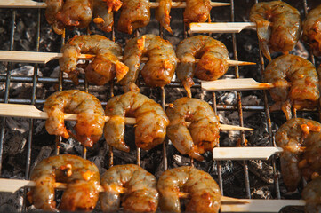 Fresh shrimp skewers grilled over charcoal © Lili