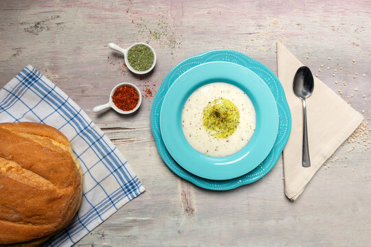 Traditional Creamy Yoghurt Soup with Olive Oil Drizzle and Spices Top View