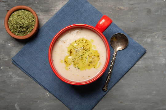Traditional Turkish yogurt soup with rice and dried mint