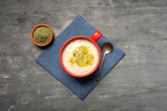 Traditional Turkish yogurt soup with rice and dried mint