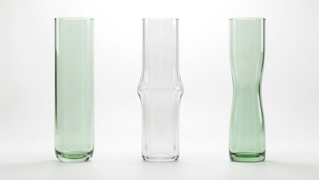 Three tall glass vases with green tints and unique silhouettes on a white background