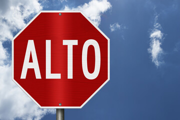 Red stop Alto Spanish sign with sky © Karen Roach