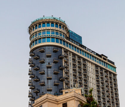 Batumi, Georgia - September 2, 2026: Architectural detail of the modern curved glass crown and unique balcony rows of the Orbi Sea Towers high-rise hotel. Travel