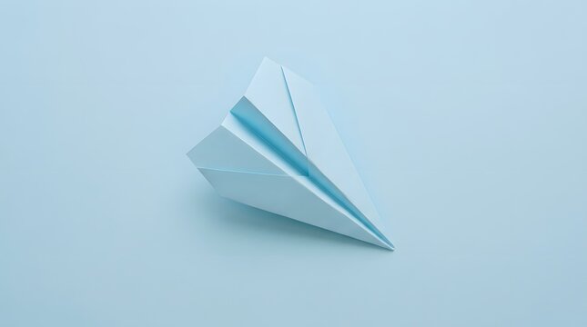 A single white paper airplane flying against a plain light blue background representing travel and creative ideas