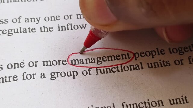 Hand with red pen mark circle to emphasize or highlight Management word on business document page. Manager person focus on project management challenges, failure, bad decisions or failed plan.