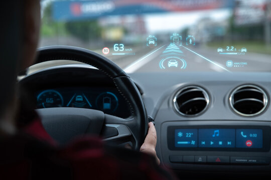 AI ​​driver assistance, augmented reality monitors vehicles, pedestrians, speed, distance. The driver keeps hands on the steering wheel, artificial intelligence road analysis, hands-free conversation.