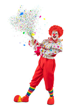 Funny clown pulling carnival cracker. Entertainer Joker in colorful suit and wig.Trickster, jester, pantomime, mime whiteface makeup. Professional actor at event, kids party, circus.