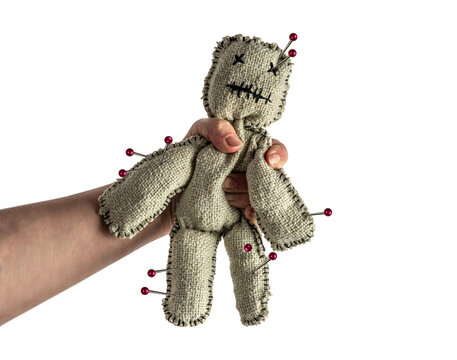 Homemade voodoo doll on isolated background. Hand squeezing toy for halloween ritual, spells, revenge