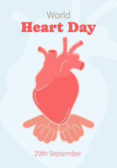 Obraz premium World Heart Day. A red heart is held by human hands.