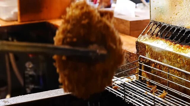 Learn professional culinary steps for preparing delicious Japanese katsudon featuring thick meat cutlets coated in breadcrumbs and deep fried in hot oil until golden brown