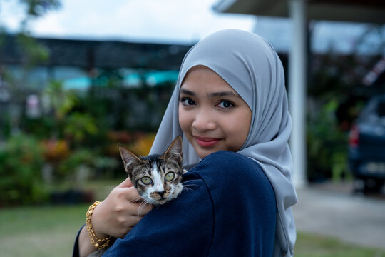 Happy young woman with tabby cat
