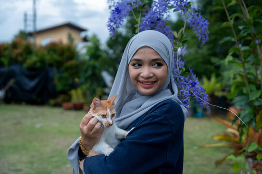 Happy young woman with orange ginger cat