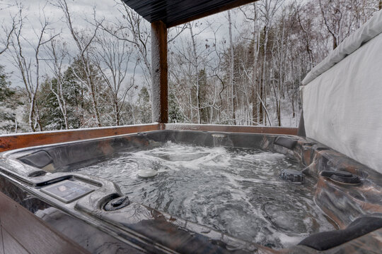 Close up of a hot tub in a mountain cabin on a snowy day