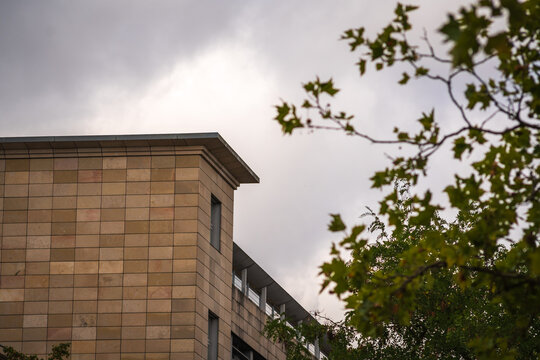 Modern Brick Apartment Building With Balconies Under Overcast Urban Sky in England UK