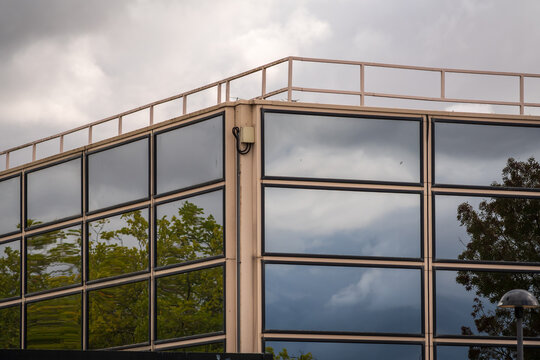 Modern Glass Office Building With Blue Reflection And Abstract Facade In Urban Architecture in England UK