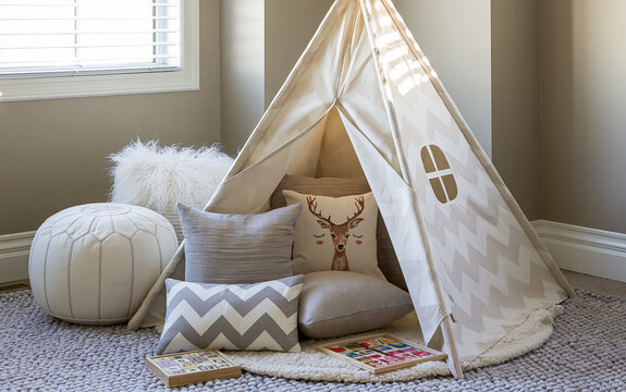 Cozy teepee play area with cushions and games