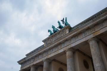 Brandenburg Gate or Brandenburger Tor monument biggest landmark in Berlin, Germany close up low angle view with grey moody sky background © elifilm