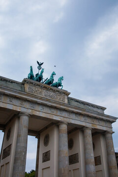 Brandenburg Gate or Brandenburger Tor monument biggest landmark in Berlin, Germany close up low angle view with grey moody sky background