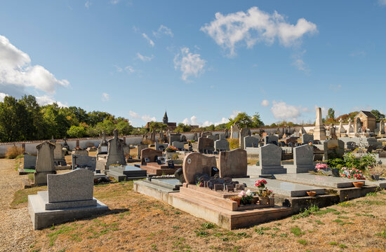 Rural cemetery, gravestones and church in Sommecaise, Yonne, France