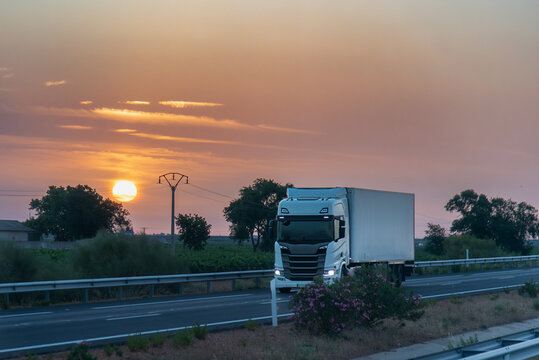 Reefer Truck Transporting Temperature Controlled Cargo at Sunset