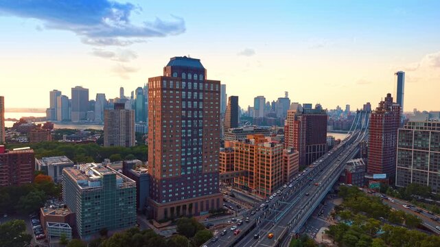 Brooklyn neighborhood of DUMBO in New York City during a warm sunset or sunrise. A busy multi-lane highway, the Manhattan Bridge approach