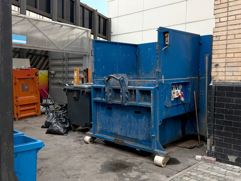 Trash compactor at a household waste sorting center. Eco centers and nature care concept. Handheld smartphone photo, selective focus, not AI