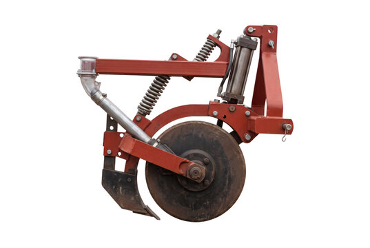 Agricultural tractor plough disc harrow implement with red metallic support frame and rotating wheel. Heavy farm machinery cultivation attachment isolated on white background setting scene.