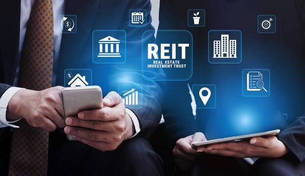 Hands of Business Professionals Engaged in Digital Communication With Financial Graphs and Icons Representing Real Estate Investment Trust Concepts. Glyphic.
