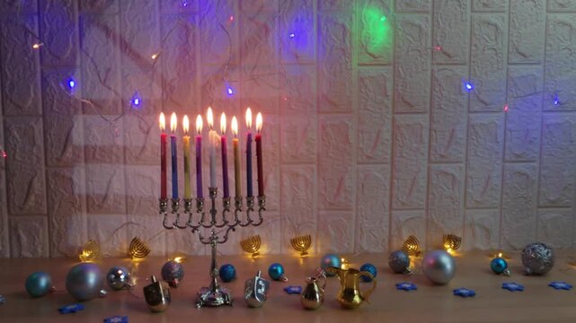 Hanukkah menorah with burning candles and dreidels