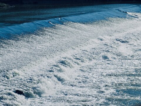 Close-up of rushing foaming water at a river weir