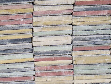 Stacked colorful concrete paving tiles texture close-up