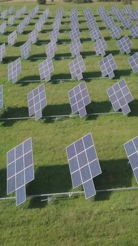 Aerial view of solar panel farm on green field