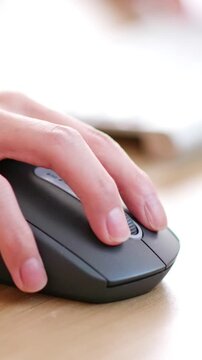 Close up of a hand using a computer mouse