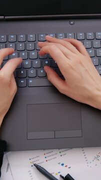 Female using laptop computer on office table
