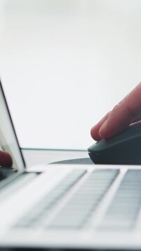 Hand using computer-mouse in office setting