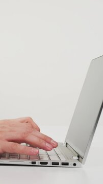 Person typing on laptop at desk in office
