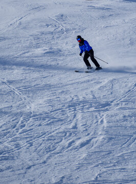 Skier carving a turn on a piste at Zell am See Austria
