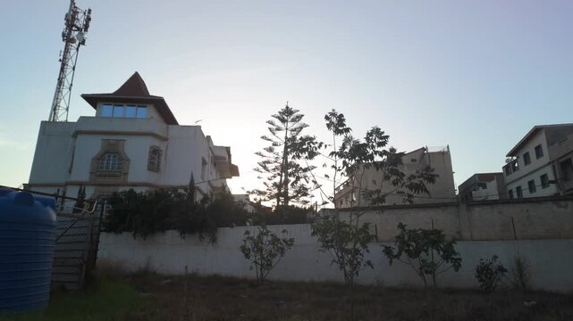 Residential Neighborhood at Sunset with Trees and Water Tank