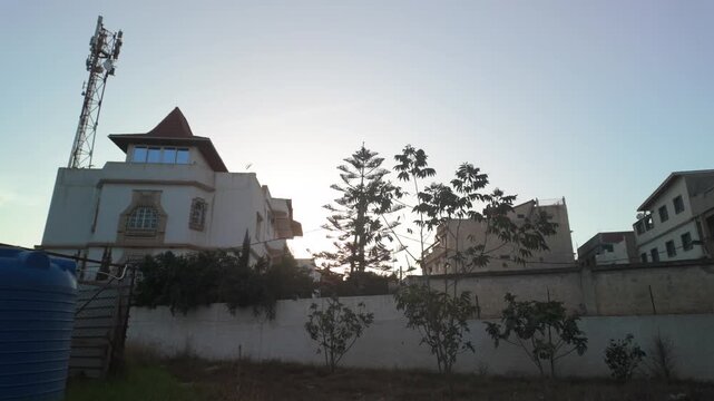 Residential Neighborhood at Sunset with Trees and Water Tank