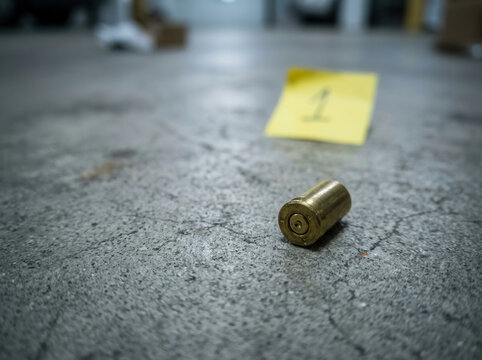 Crime Scene Evidence Bullet Casing And Marker On Floor